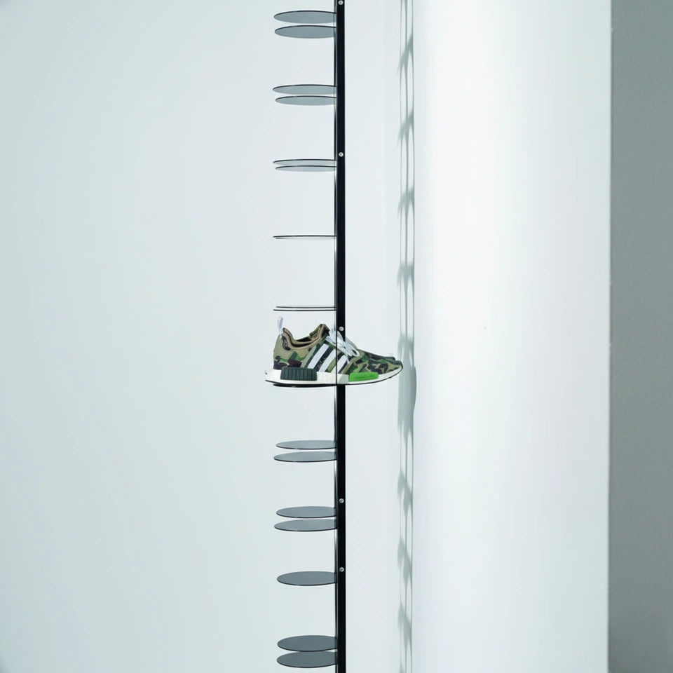 Wall-mounted metal shoe rack in matte black finish by MettiQ